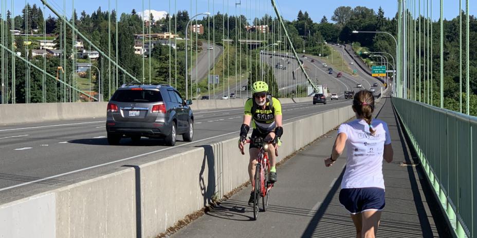 Cyclist and runner on bridge
