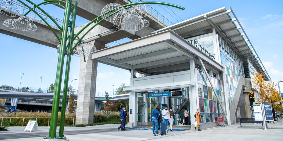 People standing outside of train station entrance