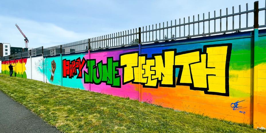 Multicoloured mural with the words "Happy Juneteenth" written on it