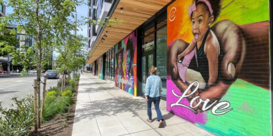 Person walking by mural