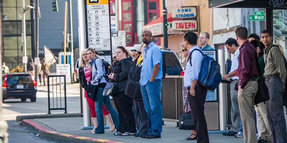 People standing at a bus stop in Seattle.