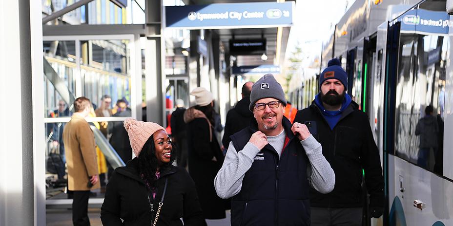 Passengers disembarking from a light rail car.